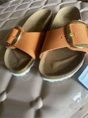 Orange Birkenstock Vegan Footbed in Tan with gold buckle